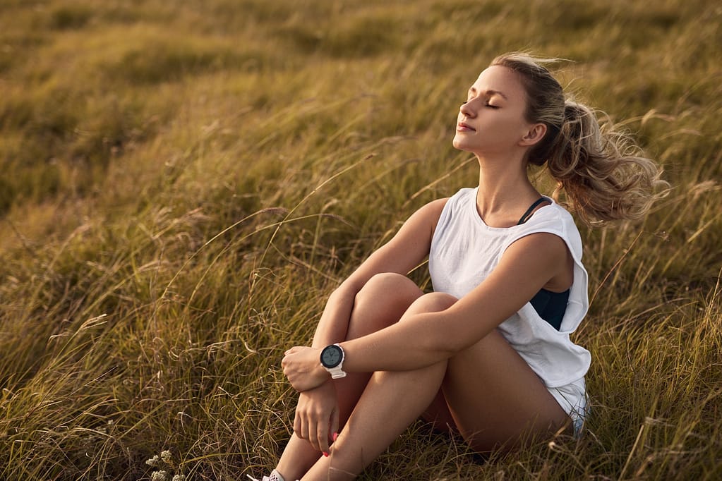 Young woman enjoying wind in nature