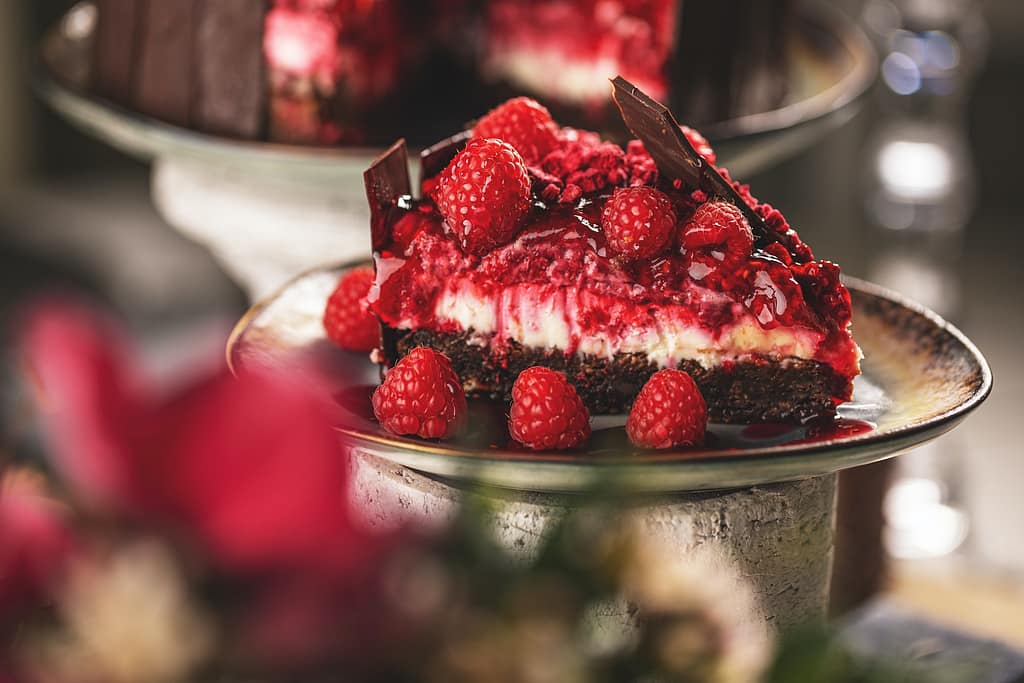 Slice of chocolate cake with raspberries